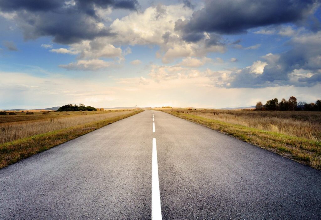 road, pavement, landscape, roadway, nature, drive, route, way, asphalt, countryside, horizon, fields, clouds, sky